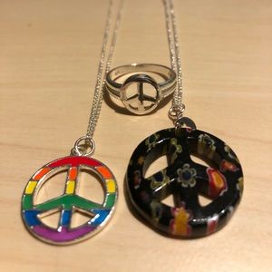 Two peace sign necklaces and a peace ring.